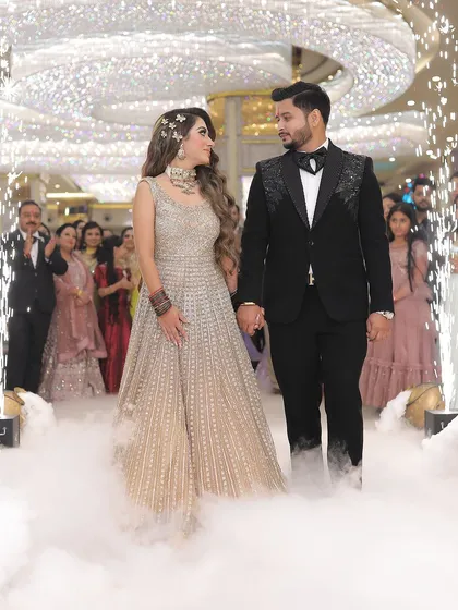 The grand entrance of the couple at their reception, complete with cold pyro and smoke effects. We are equipped to capture the scale and excitement of large-scale wedding celebrations.