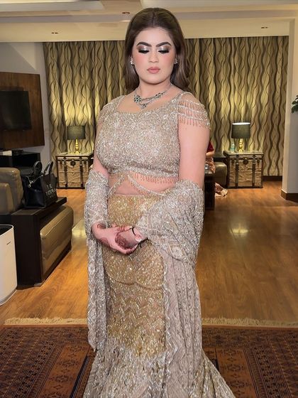 A close-up with eyes closed, showing the beautiful blend of gold and bronze eyeshadows. This is a classic glam eye look that suits many skin tones.