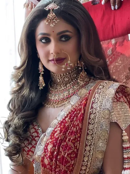 A bride's glow is a moment to treasure. This close-up showcases the soft glam and subtle highlights that brought this bride's look to life, complementing her Manish Malhotra outfit perfectly.
