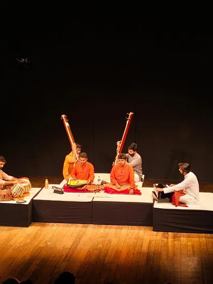 A wide shot of the stage at Prithvi Theatre, showing the full ensemble for the vocal duet performance.