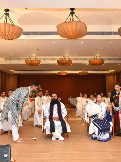 A participant showing respect to Guruji during a session.