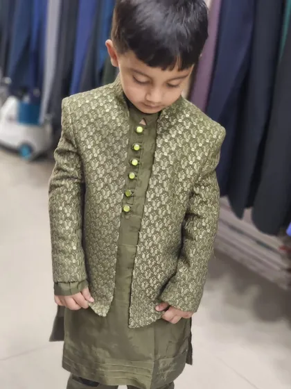 A full look at the custom-tailored olive green Indo-Western outfit for one of my youngest clients. The jacket features a subtle pattern and is paired with a matching kurta.