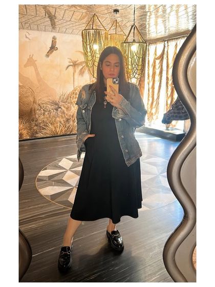A classic look for when the denim jacket weather finally hits. This mirror selfie shows how I style a simple black dress and loafers with a denim jacket for a timeless, casual outfit.