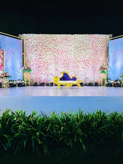 The lighting on this stage highlights the texture of the flower wall and the beautiful marble-effect side panels.