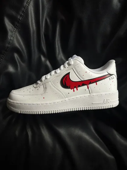 A side profile of the other shoe in the red drip pair.