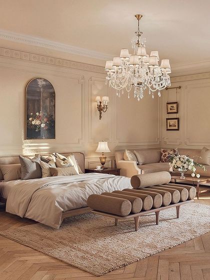 A different view of the French-inspired bedroom, highlighting the beautiful wall paneling and the soft, diffused light from the large window. The space is a perfect example of a cozy and refined ambiance.