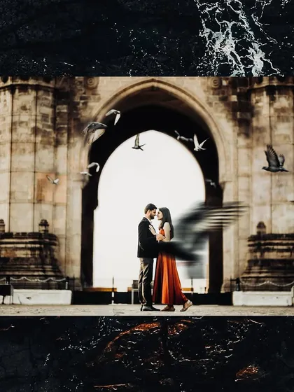 A classic romantic portrait set against Mumbai's iconic Gateway of India. The flight of pigeons adds a dynamic and timeless feel to this urban pre-wedding photograph.