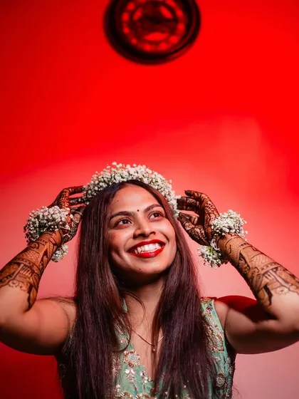 A happy bride with a floral crown, her smile is infectious.