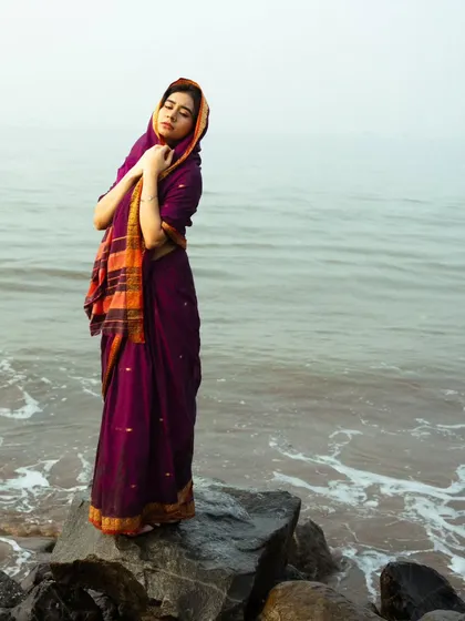 A serene, eyes-closed pose that conveys a sense of peace and connection with the surrounding nature.