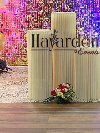 The pedestals and sequin backdrop for the 40th birthday party, creating an elegant space for the cake and gifts.