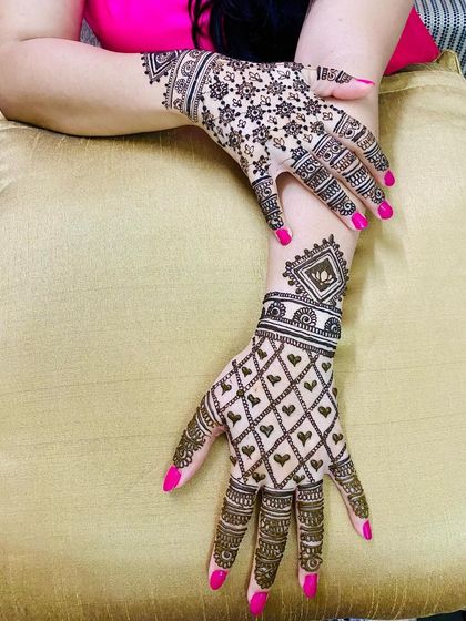 A modern take on the classic jaal (net) pattern. One hand features a net of hearts, while the other has a star-like floral pattern, creating a unique and stylish look.