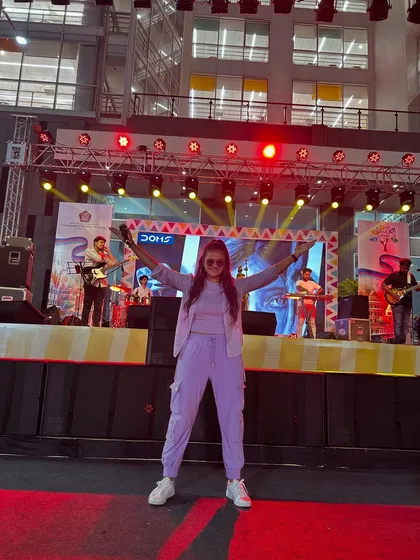 A power pose on the red carpet of the carnival stage, with the live band setting up behind me.