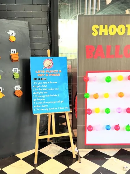 Fun and games at the art party, featuring a "Little Punch & Get A Punch" prize game and a "Shoot the Balloon" activity. We can arrange these interactive game stalls to add an extra layer of entertainment to any celebration.
