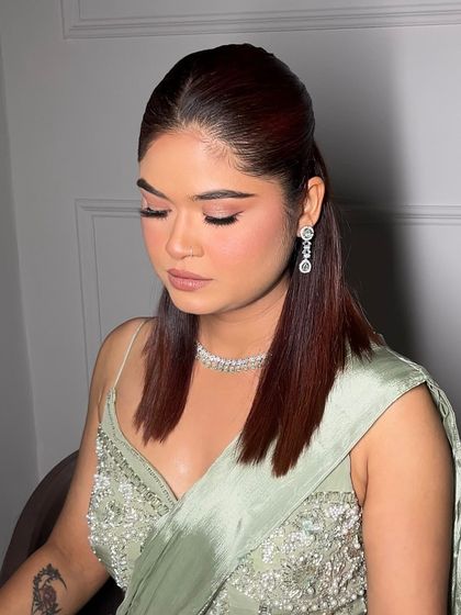 A soft glam look perfect for a cocktail party or reception. The focus is on a subtle pink eyeshadow, winged liner, and a dewy complexion.