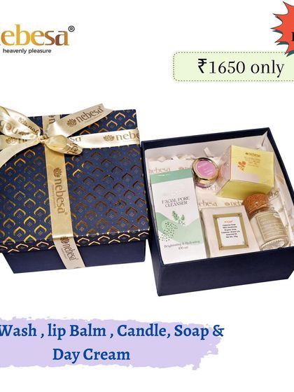 For a more luxurious Rakhi gift, I offer this hamper. It contains a face wash, lip balm, a candle, a soap, and a day cream, all presented in an elegant, reusable gift box.