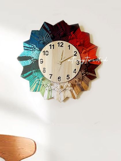 The rainbow of colors on this macramé clock makes it a joyful addition to any room. The wooden clock face provides a natural, earthy contrast to the vibrant threads.