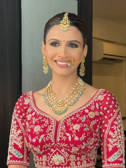 The bride's happy smile says it all. Her sleek bun keeps the focus on her radiant face, while the style remains elegant and secure throughout the festivities.