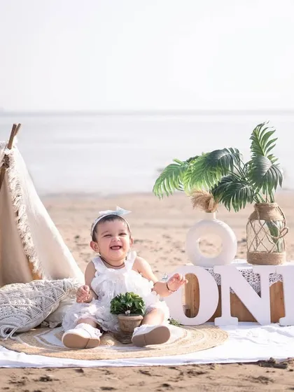 A dreamy boho first birthday on the beach. The neutral colors, teepee, and natural elements create a serene and stylish setting.
