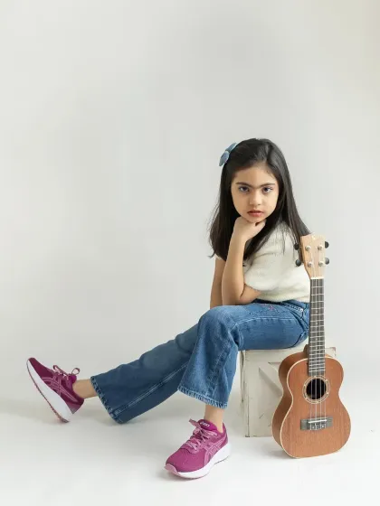 A more serious and high-fashion pose. I can guide your child through a variety of expressions for a well-rounded portfolio.