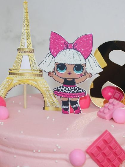 A detailed shot of the LOL Doll and Eiffel Tower toppers.
