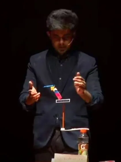 A moment of pure focus on stage. This illusion involves balancing objects in a way that seems to defy gravity, creating a silent, captivating moment for the audience.