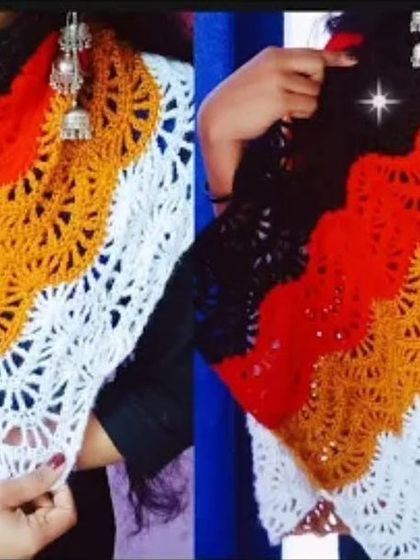 A stylish crochet shawl with a fan-like stitch pattern in black, orange, yellow, and white. This is a beautiful, custom-made accessory for any wardrobe.
