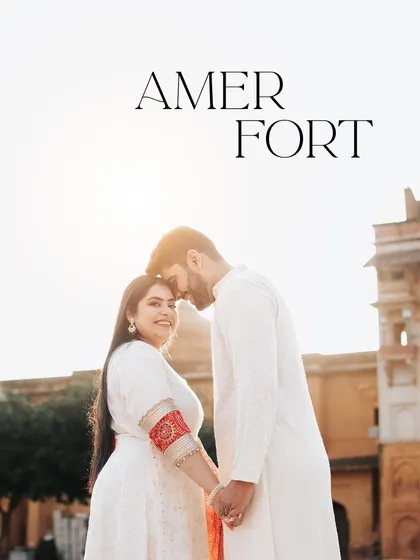 A sun-kissed portrait at Amer Fort, with a text overlay identifying the iconic location. The warm light creates a romantic and dreamy mood.