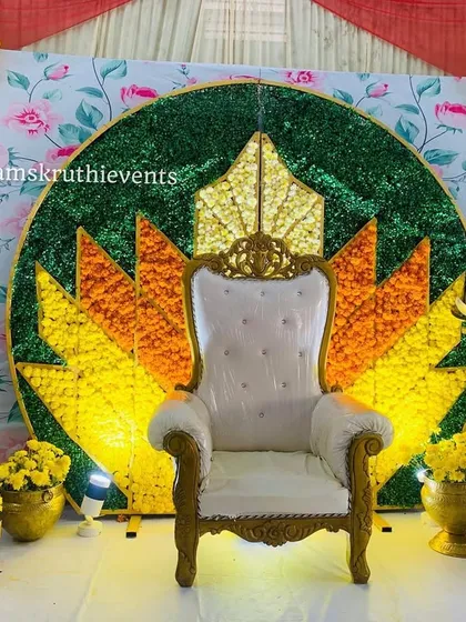 A beautiful lotus design backdrop, perfect for a baby shower or puberty ceremony. The surrounding floral arrangements and lighting make it a bright and cheerful centerpiece.