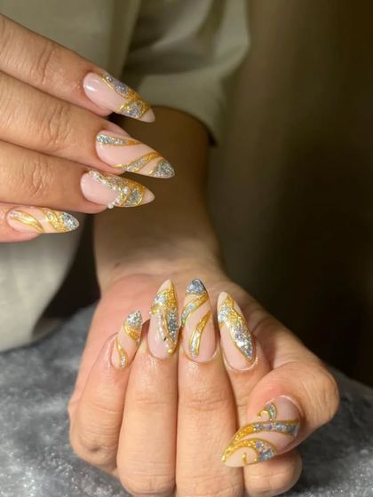 This bridal nail set is pure glamour. I used a combination of gold and silver glitter with swirling patterns over a neutral base to create a design that is both eye-catching and elegant for the big day.
