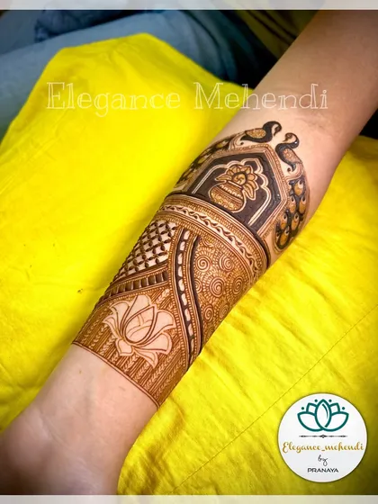 A close-up of a bridal arm design created as a demo for my students. It features a peacock pair within a jharokha and a lotus motif below.