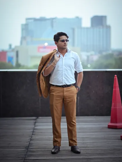 A relaxed yet stylish full-body shot with the jacket slung over the shoulder. This pose conveys a sense of ease and confidence, perfect for a more casual corporate or personal branding look.