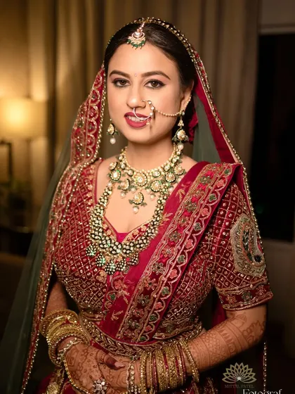 A stunning portrait of a bride in her full wedding attire. Her intricate mehndi is a key part of her regal look, adding to her beauty and grace.