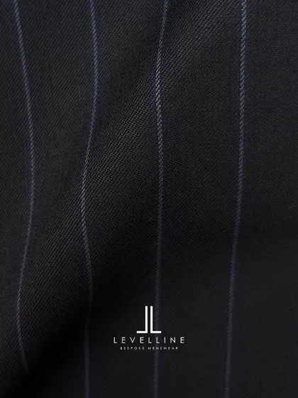 A classic navy pinstripe wool from our premium collection. This fabric creates a suit that is both timeless and authoritative.