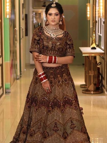 A full-length view of the brown velvet lehenga, showcasing its regal design and flattering silhouette. This is a sophisticated option for any formal wedding event.