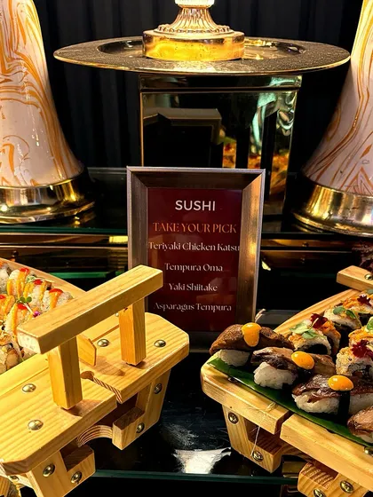 Our sushi station, elegantly presented with a variety of rolls and nigiri. The menu offers a selection of fillings, from Teriyaki Chicken Katsu to Asparagus Tempura, ensuring there's something for everyone.