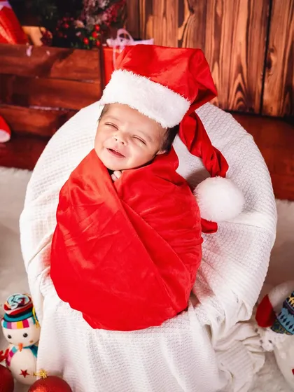 A heart-melting smile from a sleeping newborn in a Santa hat. These are the precious, candid moments I watch for during every session.