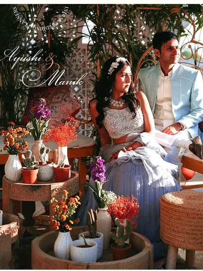 A magical portrait of the couple amidst their beautifully decorated Mehendi setting. The vibrant flowers and rustic elements create a perfect frame for their love story.