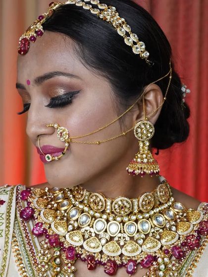 This bride is glowing in a multi-layered Kundan set with rich ruby accents. Renting allows you to wear such a statement piece for your big day.