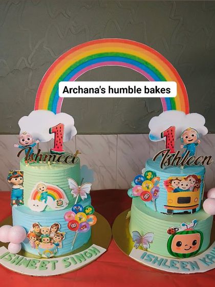 A pair of matching Cocomelon cakes for twins, Ishmeet and Ishleen. Each cake is personalized but shares the same joyful theme.