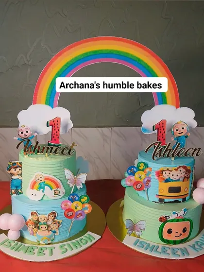 A pair of matching Cocomelon cakes for twins, Ishmeet and Ishleen. Each cake is personalized but shares the same joyful theme.