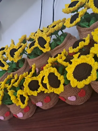 An angled shot showing the row of handmade sunflower pots, each one crafted with the same care and attention to detail.