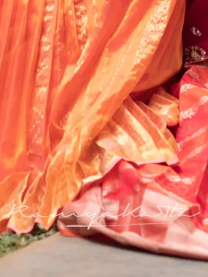 A close-up on the textures and fabrics of our creations, from pleated silks to rich brocades.