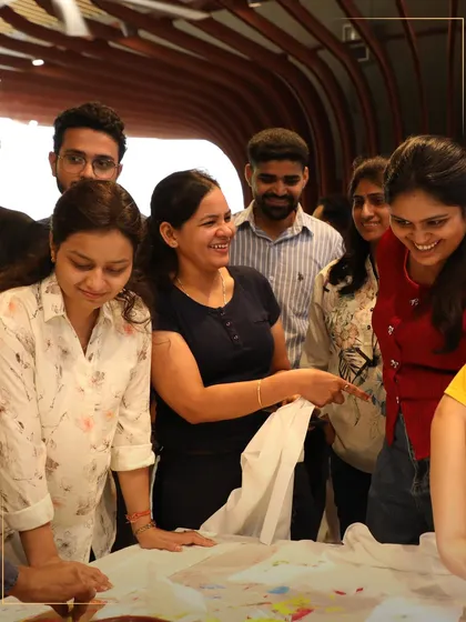 A group of smiling participants at a creative workshop. The joy and camaraderie in this photo highlight the community aspect of our hands-on events.