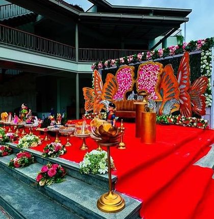 An angled view of the butterfly-themed stage, showing the red carpet aisle leading up to it.