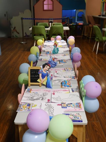A dedicated coloring station set up for a princess party. We can include creative activities like coloring, with themed sheets and supplies, to offer a calm-down moment during the party.