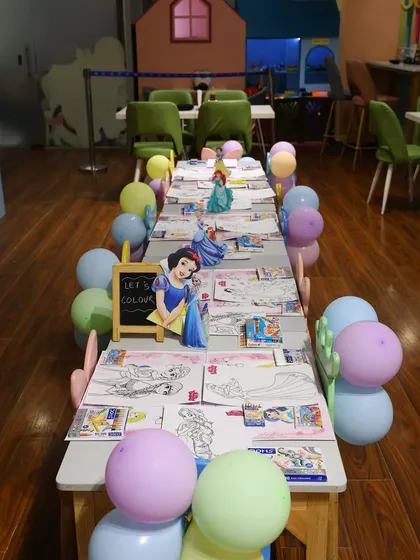 A dedicated coloring station set up for a princess party. We can include creative activities like coloring, with themed sheets and supplies, to offer a calm-down moment during the party.