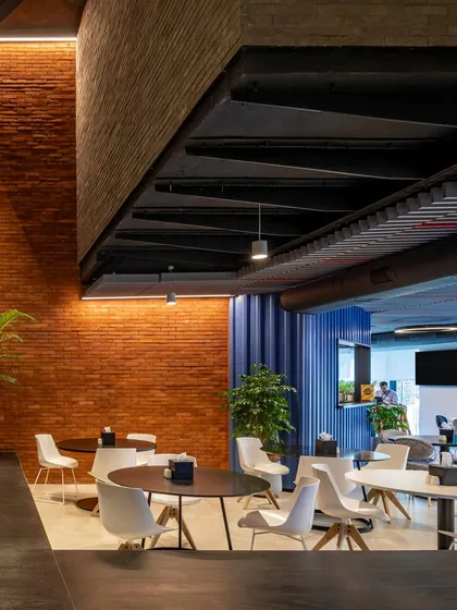 The interplay of brick, steel, and a vibrant blue wall in the BCG HQ cafe area demonstrates our approach of merging simple materials with bold design gestures.