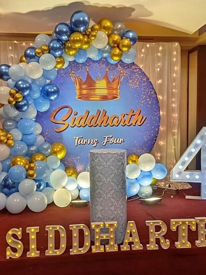 A royal prince theme for Siddharth's fourth birthday, using a blue and gold color scheme with a crown motif on the backdrop.