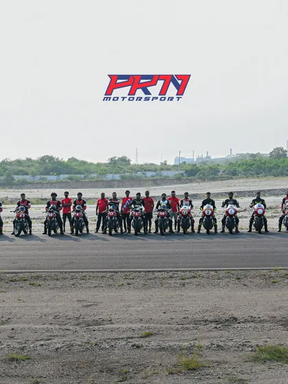 A group photo of our riders and coaches on the track, capturing the sense of community.