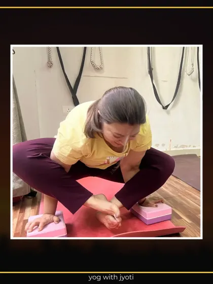 A student uses yoga blocks under her hands and feet to get the feel of Bhujapidasana, modifying the pose to her current level.